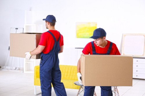 Moving team working in a West Kensington street with residential flats