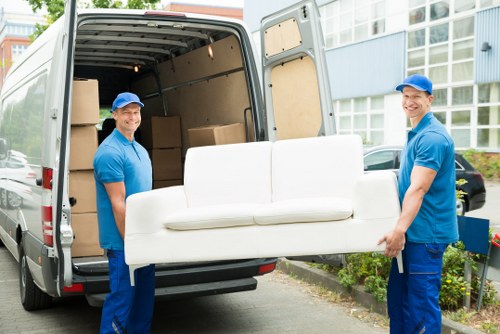 Man with van vehicle loading furniture in West Kensington street