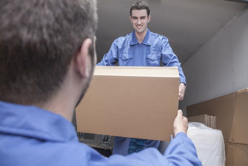 Man and van loading furniture in a West Kensington residential street