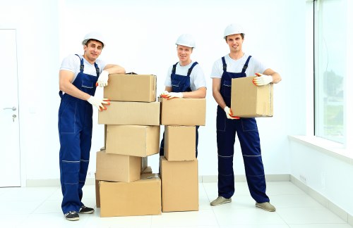 Office furniture and documents being organised for a commercial move in West Kensington