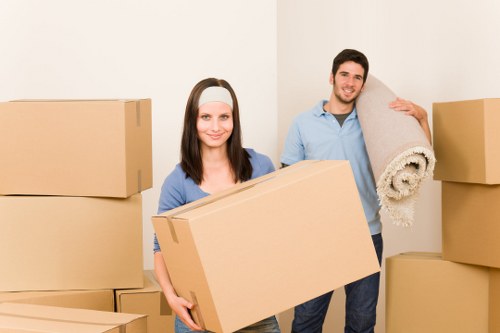 Office furniture and equipment being moved by a local removals team