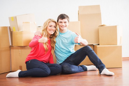 Moving team loading items carefully for a flat removal in West Kensington