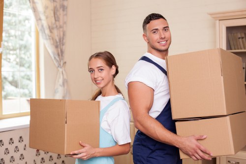 Packed moving boxes and furniture prepared for a West Kensington house or flat removal