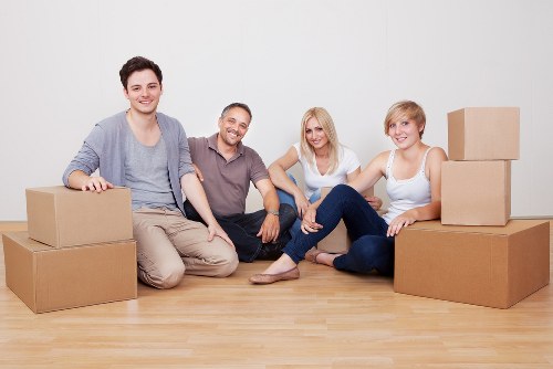 Professional movers handling furniture in a West Kensington flat
