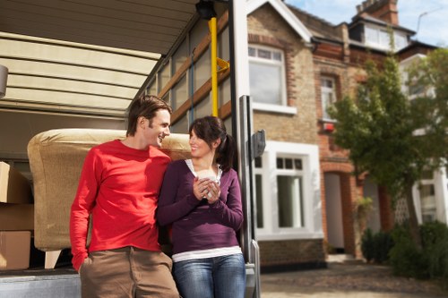 Professional movers loading household items into a removal van for a West Kensington move