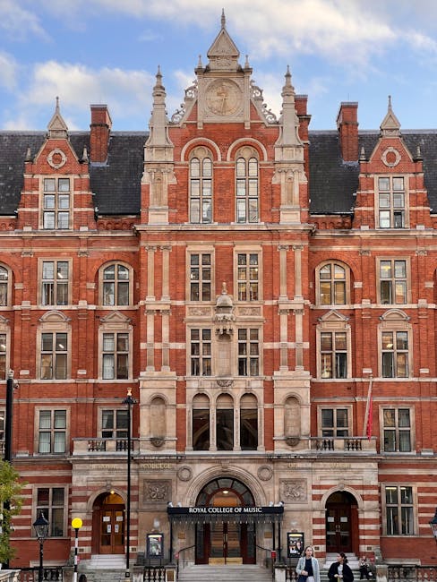 The image shows the storefront of a shop on a street in West Kensington, with a white facade and large windows on the upper floors. The ground level features an open display area with various colorful